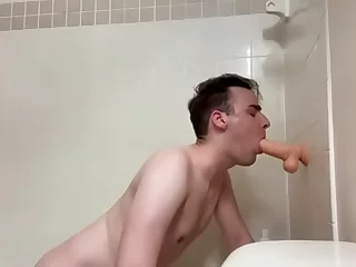 Gay twink Connor indulges in anal play with a dildo during a shower session